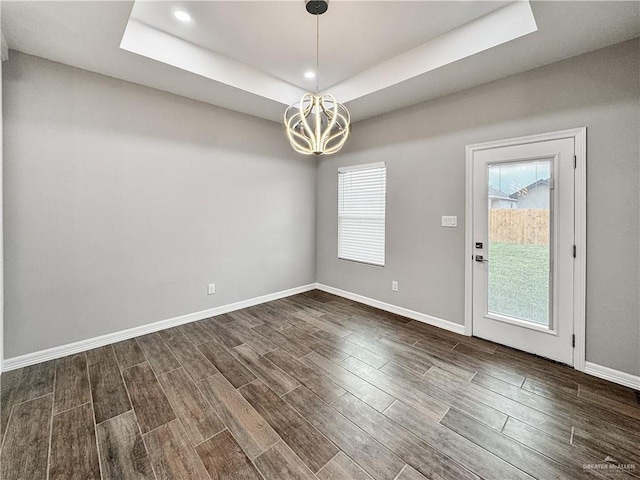 2200 Zinnia St, Weslaco, TX 78599 - spare room with a chandelier, dark wood finished floors, a raised ceiling, and recessed lighting