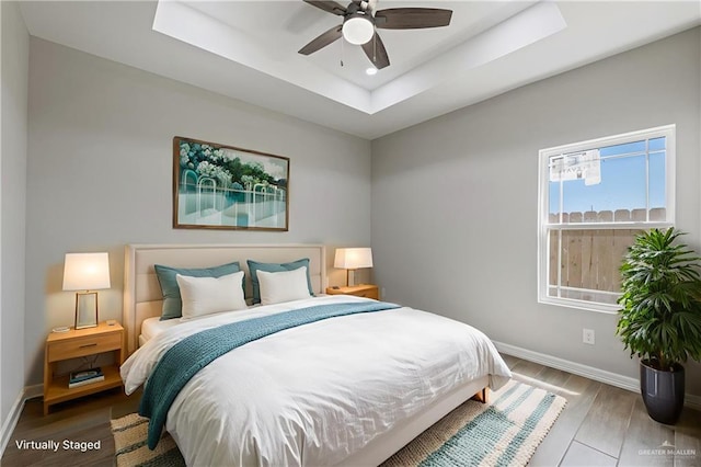 2200 Zinnia St, Weslaco, TX 78599 - bedroom featuring wood finished floors, a tray ceiling, recessed lighting, and a ceiling fan