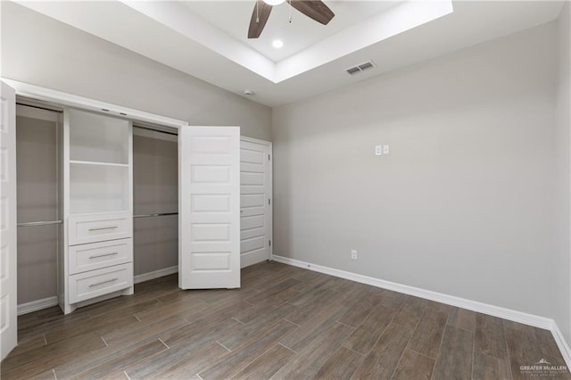 2200 Zinnia St, Weslaco, TX 78599 - unfurnished bedroom with wood finished floors, a closet, a tray ceiling, ceiling fan, and recessed lighting