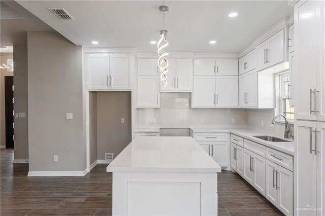 2200 Zinnia St, Weslaco, TX 78599 - kitchen featuring a center island, recessed lighting, white cabinetry, and dark wood-style flooring