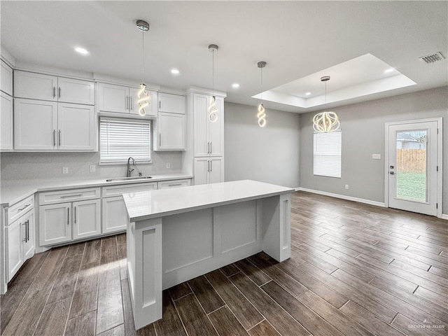 2200 Zinnia St, Weslaco, TX 78599 - kitchen with light countertops, a center island, dark wood finished floors, white cabinetry, and recessed lighting