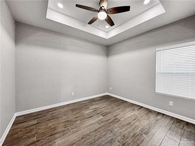 2200 Zinnia St, Weslaco, TX 78599 - empty room with ceiling fan, wood tiled floors, a tray ceiling, and recessed lighting