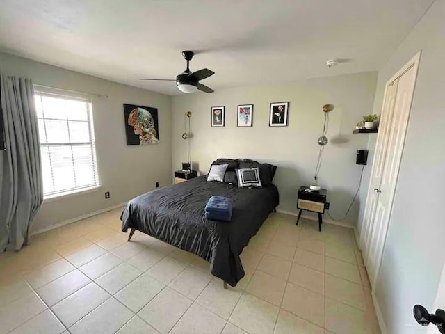 bedroom with ceiling fan and light tile patterned floors