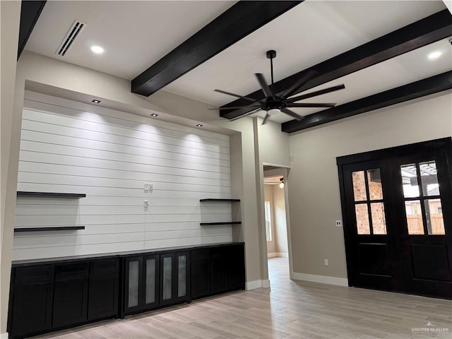 foyer entrance featuring light hardwood / wood-style flooring, beamed ceiling, french doors, and ceiling fan