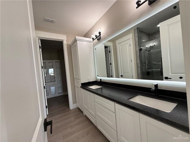 bathroom featuring vanity, an enclosed shower, and hardwood / wood-style floors