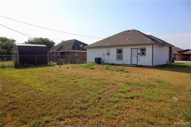 rear view of house featuring a lawn