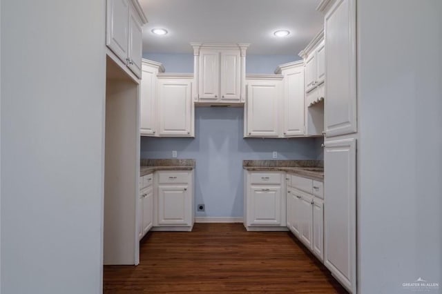 kitchen featuring white cabinets and dark wood-type flooring