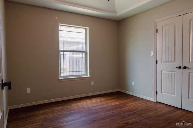 spare room with dark hardwood / wood-style flooring