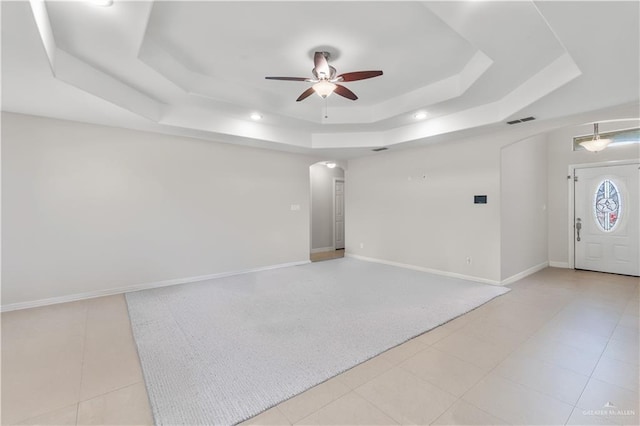 spare room with recessed lighting, ceiling fan, visible vents, arched walkways, and a raised ceiling