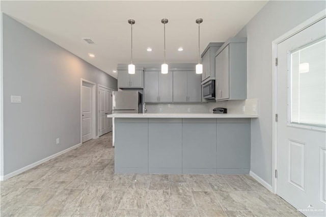 203 W Campeche Ave, Alton, TX 78573 - kitchen with light countertops, a peninsula, stainless steel appliances, tasteful backsplash, and gray cabinetry