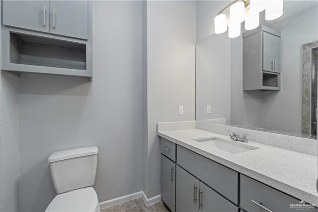 203 W Campeche Ave, Alton, TX 78573 - bathroom with baseboards, toilet, and vanity