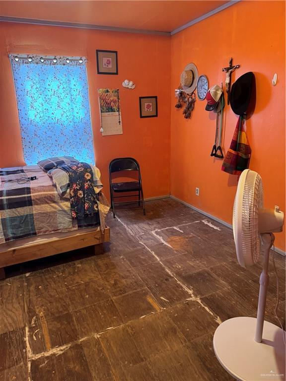 bedroom with baseboards and ornamental molding