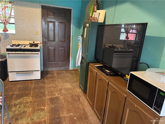 kitchen featuring tile patterned floors and white range with gas cooktop