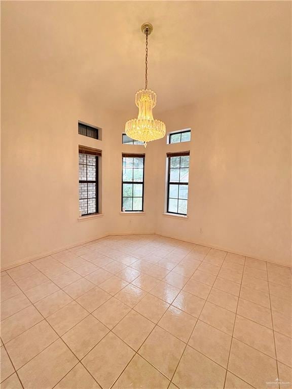 2218 Lawndale Rd, Mission, TX 78572 - spare room featuring an inviting chandelier, light tile patterned flooring, and a towering ceiling