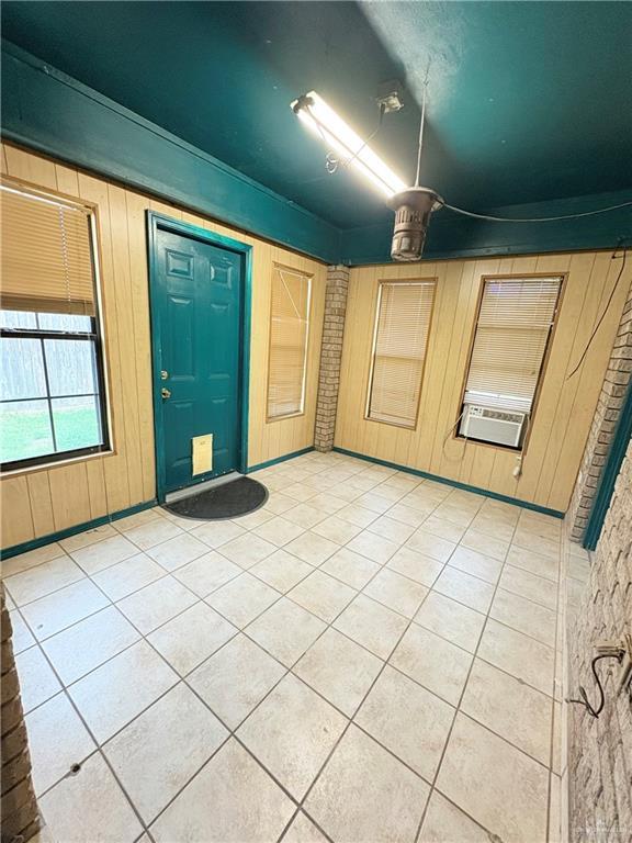 2218 Lawndale Rd, Mission, TX 78572 - entryway featuring wood walls, cooling unit, and light tile patterned floors