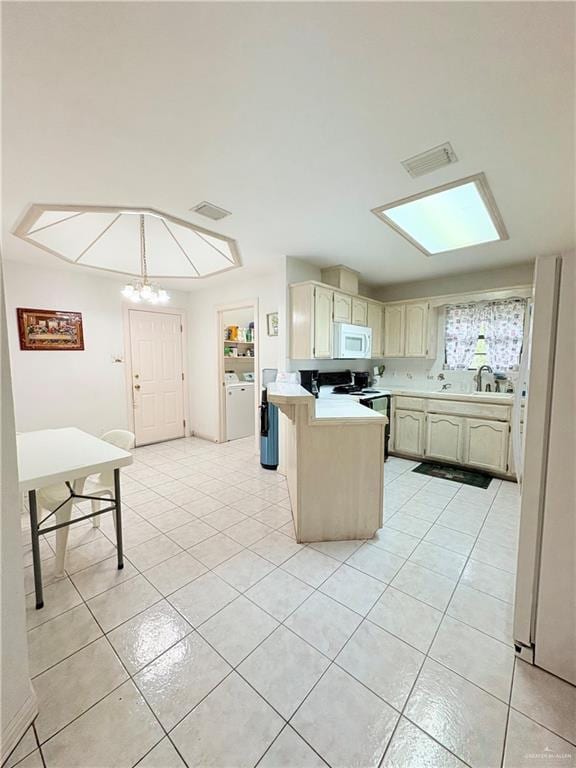 2218 Lawndale Rd, Mission, TX 78572 - kitchen with white appliances, light tile patterned floors, light countertops, a peninsula, and a notable chandelier