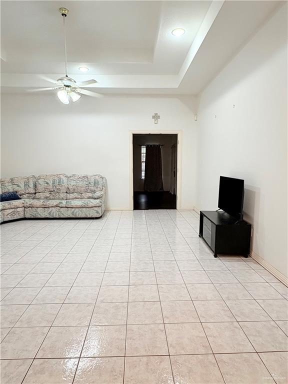 2218 Lawndale Rd, Mission, TX 78572 - unfurnished living room with a raised ceiling, ceiling fan, recessed lighting, and light tile patterned floors