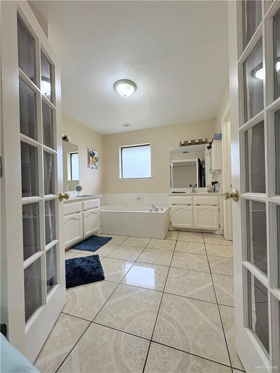 2218 Lawndale Rd, Mission, TX 78572 - full bath featuring a garden tub, two vanities, and a sink