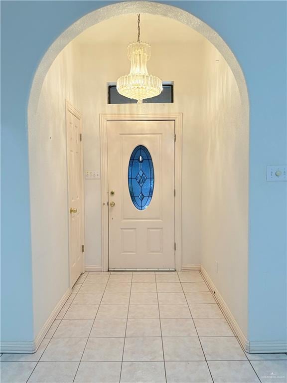 2218 Lawndale Rd, Mission, TX 78572 - doorway to outside with baseboards, arched walkways, a notable chandelier, and light tile patterned floors