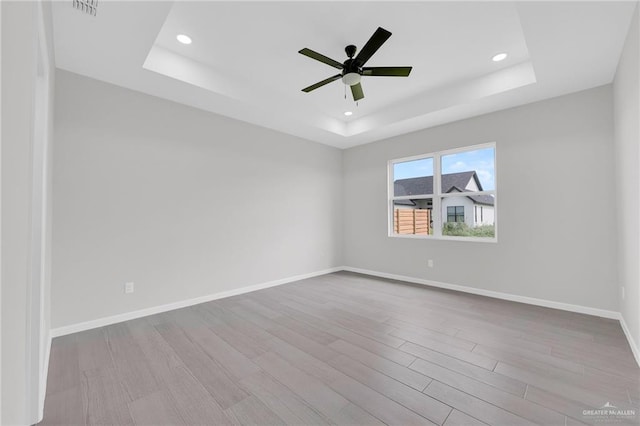 910 Azalea St, Mission, TX 78574 - spare room with a tray ceiling, wood finished floors, ceiling fan, and recessed lighting