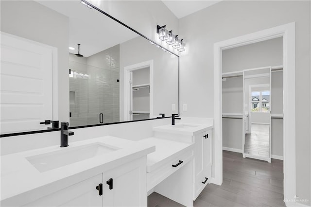 910 Azalea St, Mission, TX 78574 - full bath with a spacious closet, double vanity, a shower stall, and wood finished floors