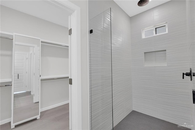 910 Azalea St, Mission, TX 78574 - full bathroom with tiled shower and wood finished floors