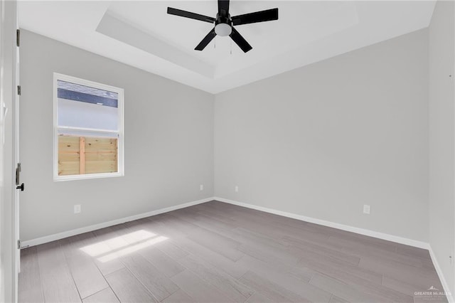 910 Azalea St, Mission, TX 78574 - unfurnished room with a raised ceiling, wood finished floors, and ceiling fan