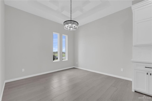 910 Azalea St, Mission, TX 78574 - unfurnished dining area featuring light wood-style floors, a chandelier, and a raised ceiling