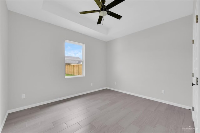 910 Azalea St, Mission, TX 78574 - spare room featuring wood finished floors, a ceiling fan, and a raised ceiling