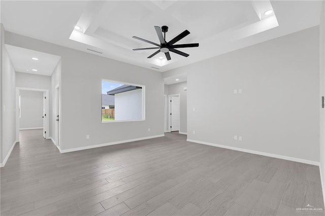 910 Azalea St, Mission, TX 78574 - spare room featuring a ceiling fan, wood finished floors, a raised ceiling, and recessed lighting