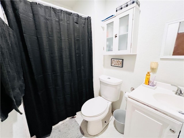 bathroom featuring tile patterned floors, vanity, and toilet