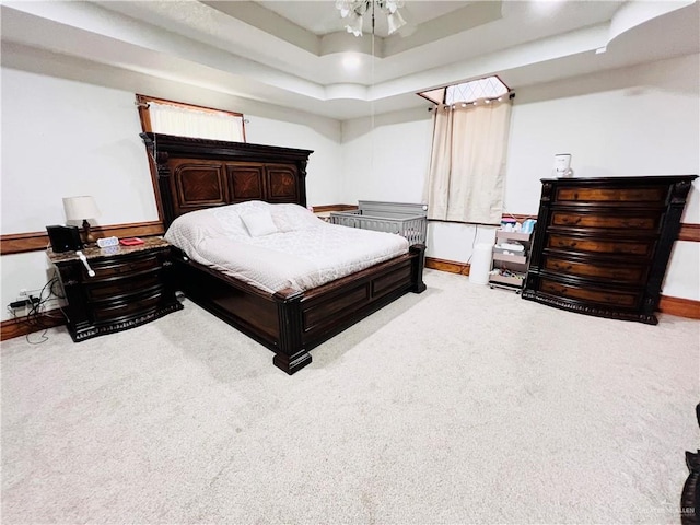 bedroom featuring carpet floors and a tray ceiling