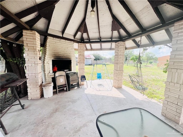 view of patio / terrace featuring a gazebo and exterior fireplace