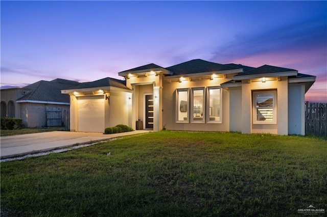 705 New Orleans Cir, Pharr, TX 78577 - prairie-style home with an attached garage, stucco siding, driveway, and a front yard