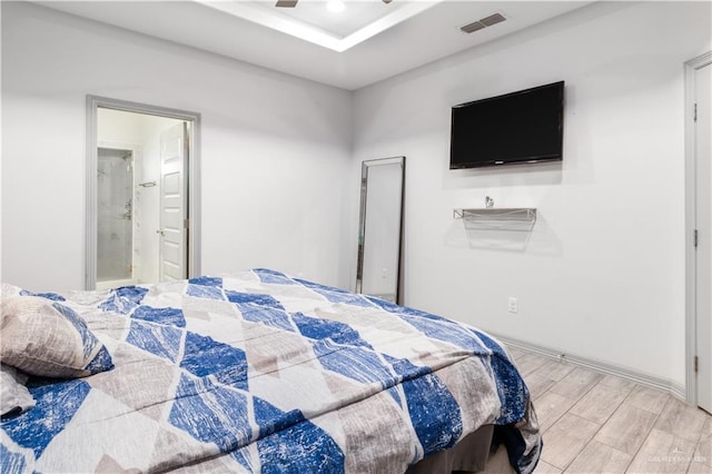 705 New Orleans Cir, Pharr, TX 78577 - bedroom with light wood finished floors, ensuite bathroom, a raised ceiling, and recessed lighting