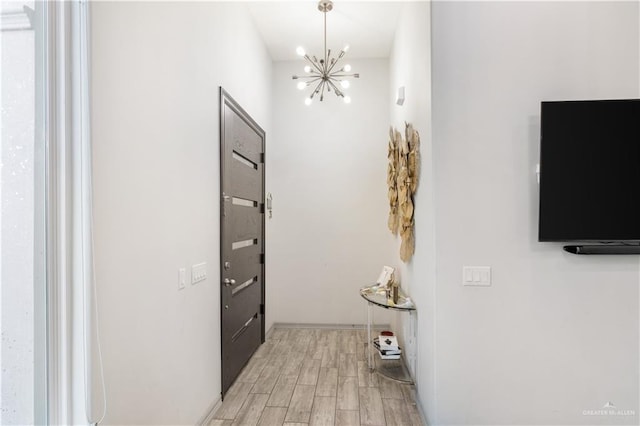705 New Orleans Cir, Pharr, TX 78577 - hallway with light wood-type flooring and a chandelier