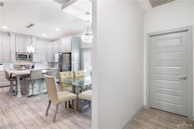 705 New Orleans Cir, Pharr, TX 78577 - dining room with light wood-type flooring, a chandelier, and recessed lighting