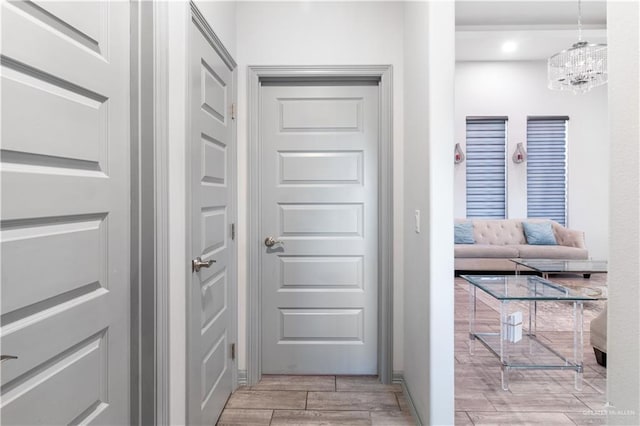 705 New Orleans Cir, Pharr, TX 78577 - corridor featuring wood tiled floors, a chandelier, and baseboards