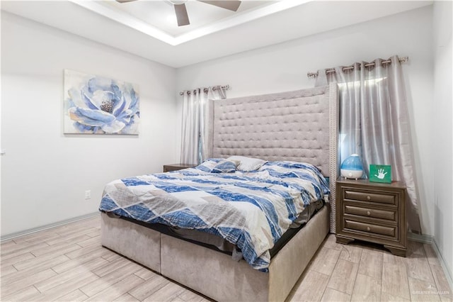 705 New Orleans Cir, Pharr, TX 78577 - bedroom with light wood-type flooring, a tray ceiling, and a ceiling fan