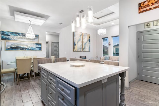 705 New Orleans Cir, Pharr, TX 78577 - kitchen with a chandelier, light wood-type flooring, a kitchen breakfast bar, and gray cabinetry