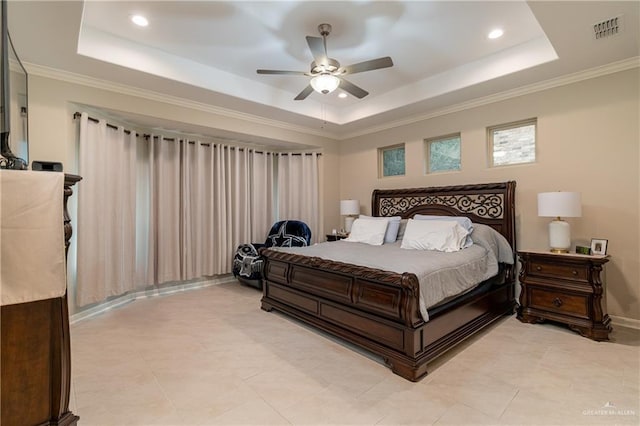 bedroom featuring visible vents, a tray ceiling, a ceiling fan, and ornamental molding