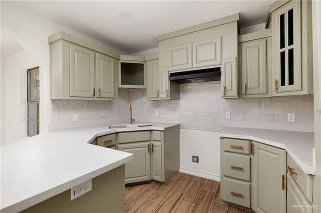 kitchen featuring backsplash, gray cabinets, and sink