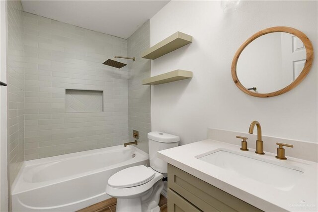 full bathroom featuring vanity, toilet, and tiled shower / bath