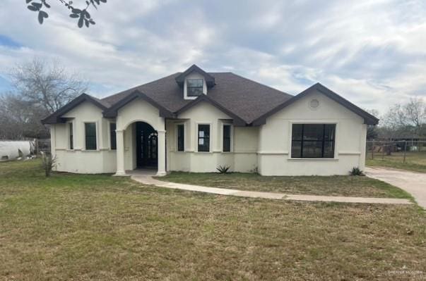 view of front of house with a front lawn and stucco siding