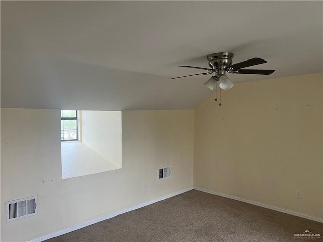 additional living space with vaulted ceiling, carpet, visible vents, and a ceiling fan