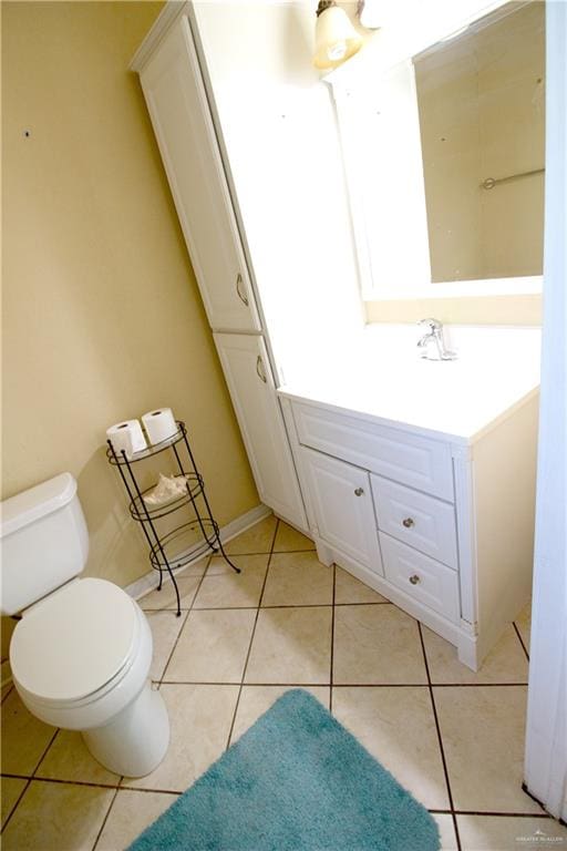 bathroom featuring tile patterned floors, vanity, and toilet