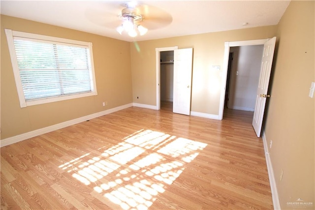 unfurnished bedroom featuring a closet, ceiling fan, and light hardwood / wood-style flooring