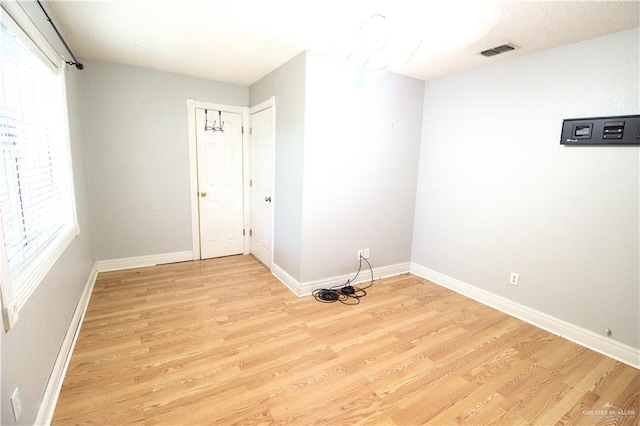 unfurnished room with light hardwood / wood-style floors