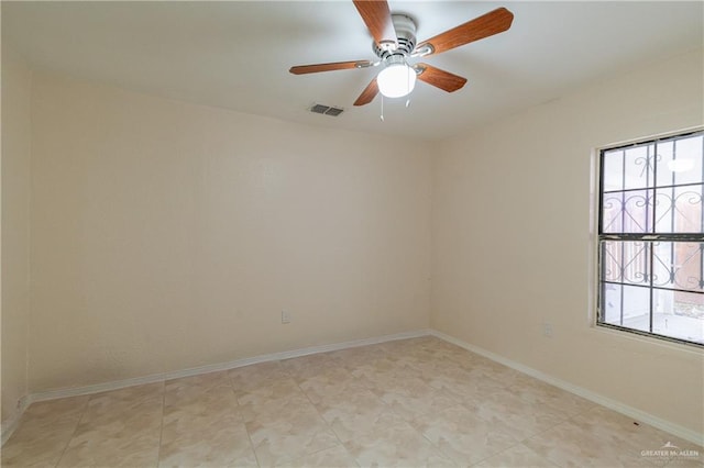 unfurnished room featuring a ceiling fan, visible vents, and baseboards