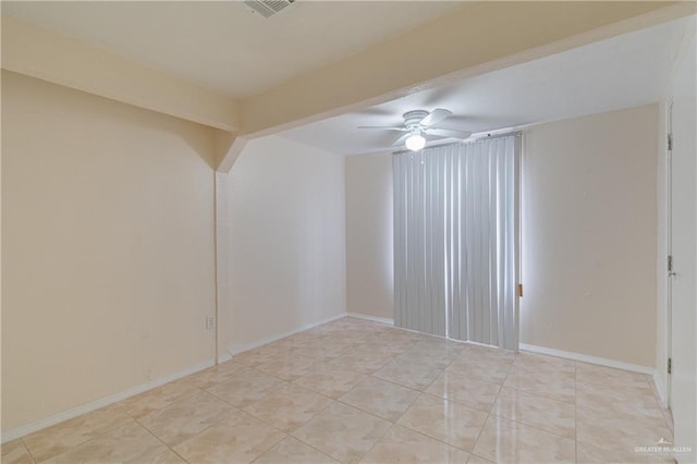 spare room with ceiling fan, visible vents, baseboards, and light tile patterned flooring